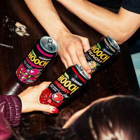 People drinking cans of Hooch premixed and ready to drink alcopops. 