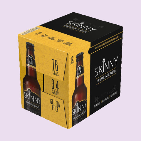 Box of Skinny Premium Lager beer on a light purple background