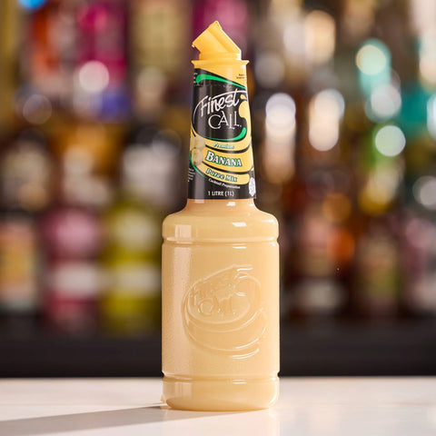 A bottle of Finest Call Premium Banana Puree Mix, perfect for mixing cocktails and mocktails. 