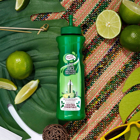 Bottle of Master of Mixes Cocktail Essentials Single Pressed Lime Juice with limes and a colorful background