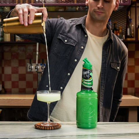 Finest Call Single Pressed Lime Juice at a bar with a bartender making a cocktail