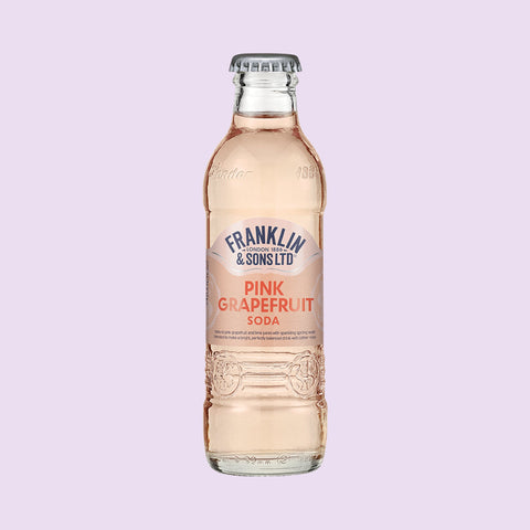 A glass bottle of Franklin & Sons pink grapefruit soda, a premium soft drink. 