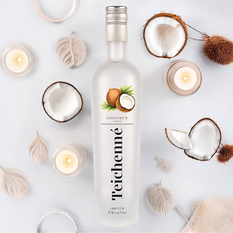 Teichenné coconut liqueur bottle with coconuts and candles on a light background