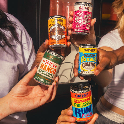 People holding different cans of GATHER. 