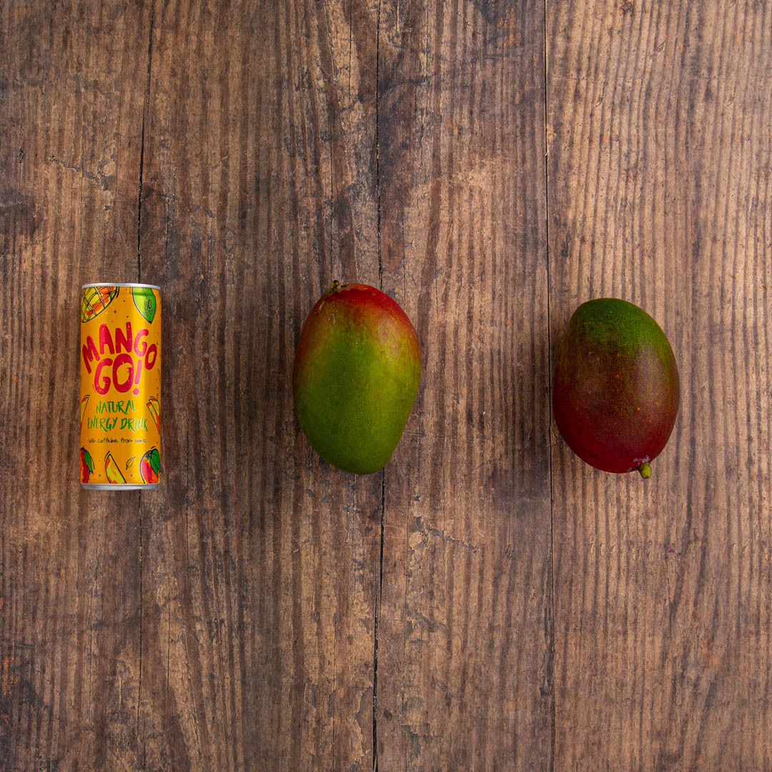 Good Time In | A can of Mango go! next to 2 mangoes