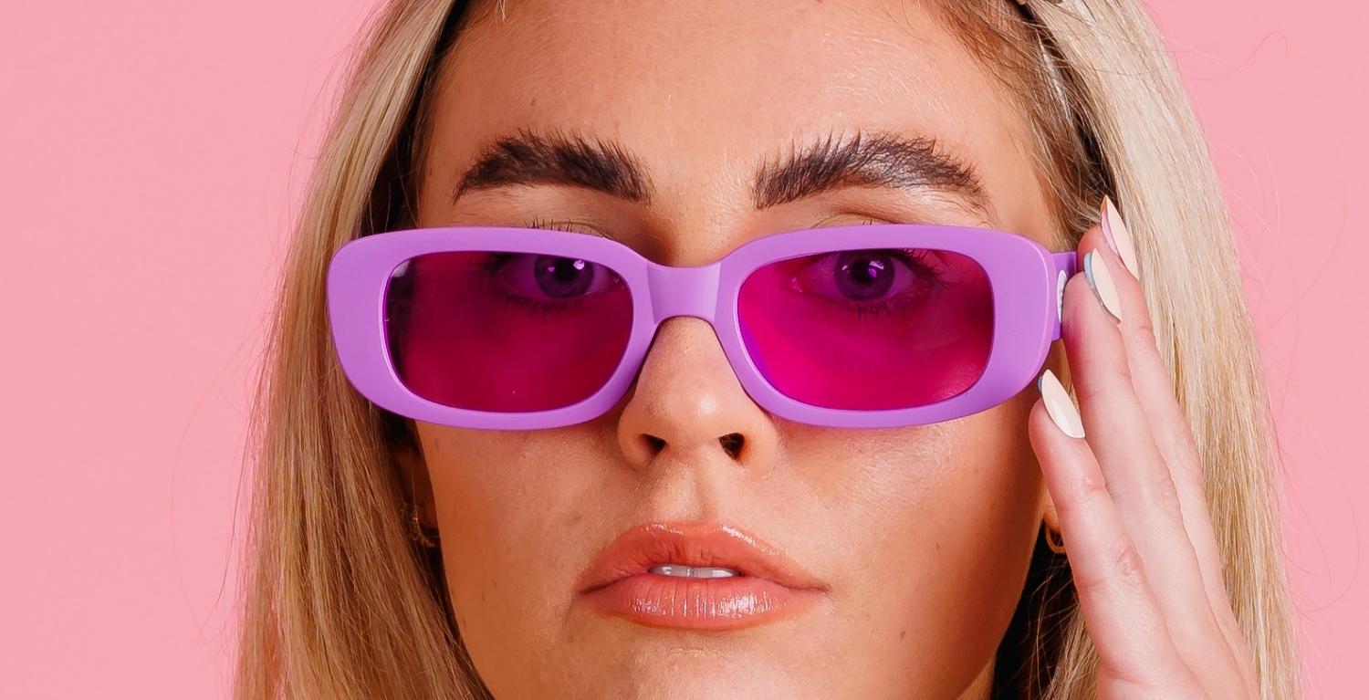 Good Time In | Close up of girl with Shake Baby Shake branded purple sunglasses on
